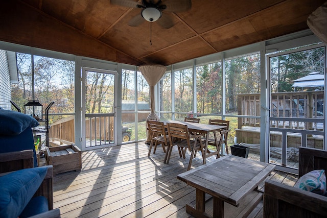 sunroom with a wealth of natural light, ceiling fan, and vaulted ceiling