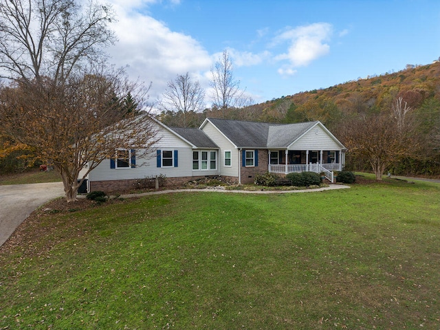 single story home with a porch and a front lawn