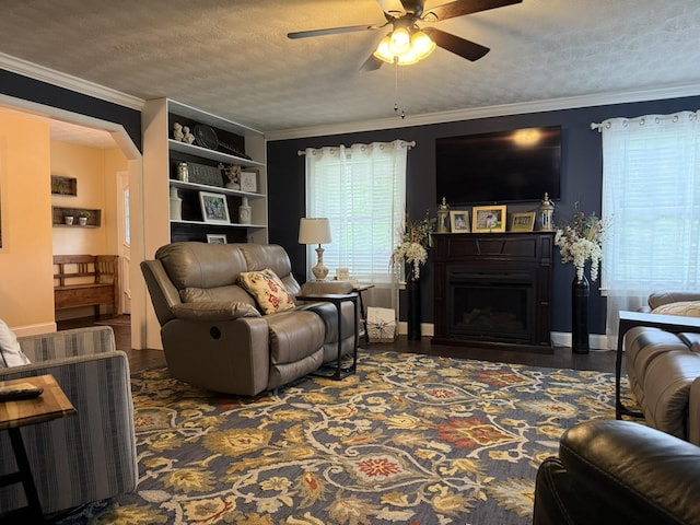 30 Meadowbrook Ln, Trenton, GA 30752 - living room featuring a ceiling fan, a textured ceiling, ornamental molding, a fireplace, and wood finished floors
