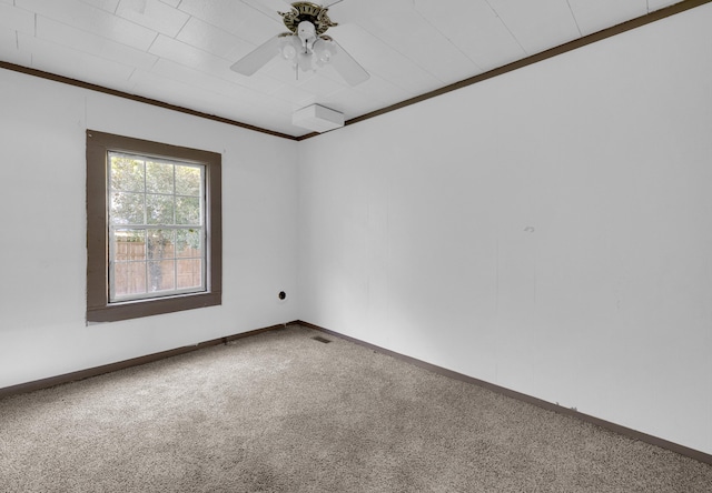 carpeted empty room featuring ceiling fan and ornamental molding