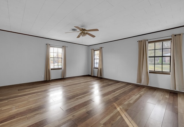 unfurnished room with ceiling fan, crown molding, and wood-type flooring