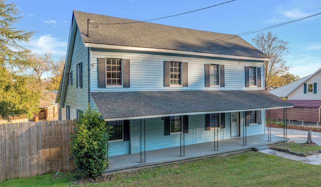 view of front facade with covered porch and a front lawn