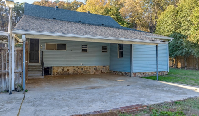 back of property with a carport