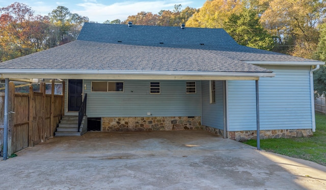 back of property featuring a carport