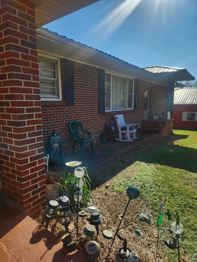 back of house with a patio area and a yard