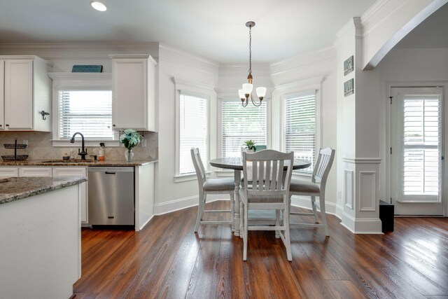 dining space with a notable chandelier, dark hardwood / wood-style flooring, and a wealth of natural light