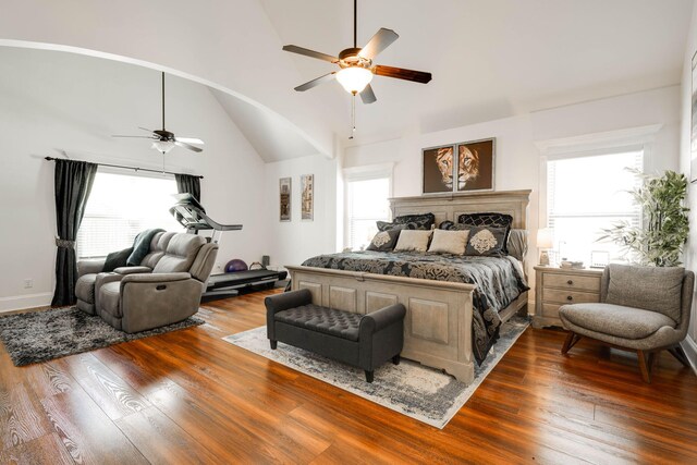 bedroom with multiple windows, hardwood / wood-style flooring, and ceiling fan