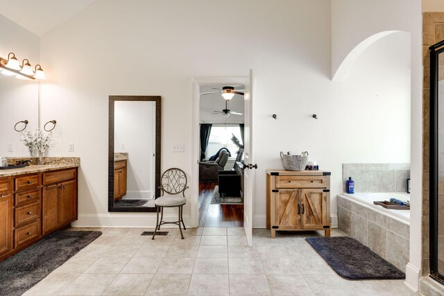 bathroom featuring vanity, high vaulted ceiling, and tile patterned floors