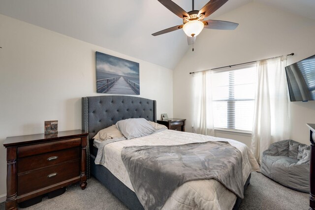 bedroom with ceiling fan, light colored carpet, and vaulted ceiling