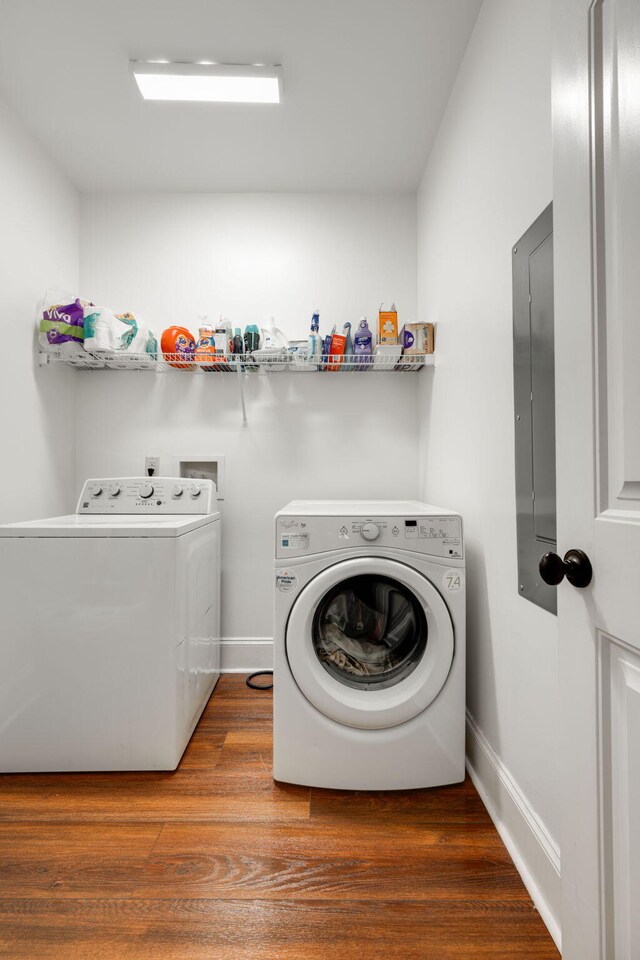 washroom featuring hardwood / wood-style floors and washing machine and clothes dryer