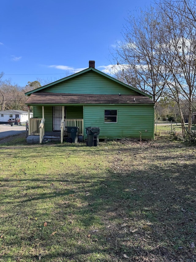 view of home's exterior featuring a lawn and a porch