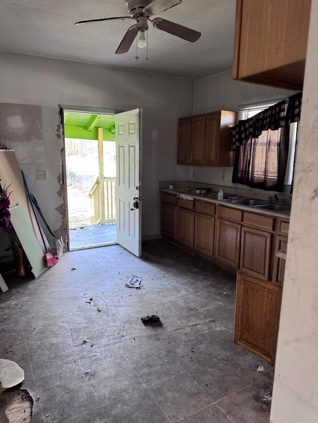 kitchen featuring ceiling fan and sink