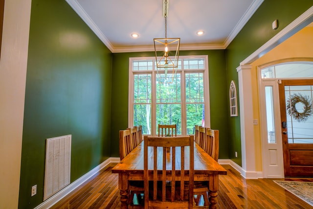 dining room featuring dark hardwood / wood-style floors and crown molding