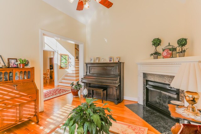 289 Magnolia Pl, Ringgold, GA 30736 - living area with stairway, ceiling fan, wood finished floors, and a fireplace with flush hearth