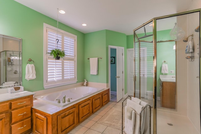 bathroom with tile patterned floors, separate shower and tub, and vanity