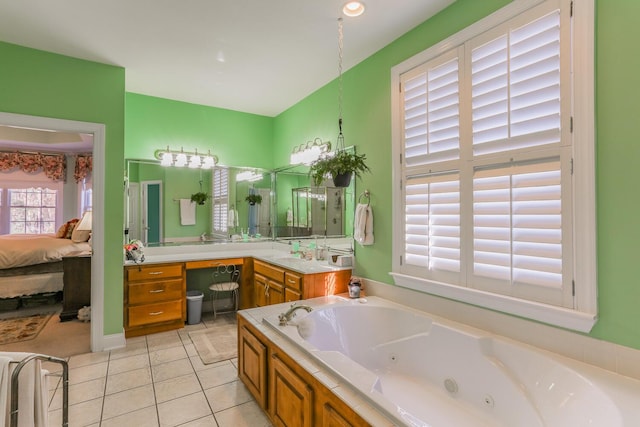 bathroom with tile patterned flooring, vanity, and a bathing tub