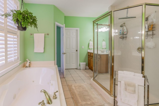 bathroom with plus walk in shower, tile patterned flooring, and sink