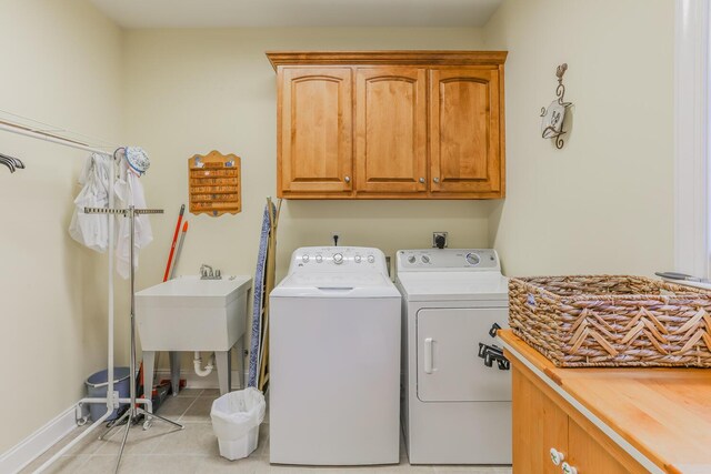 289 Magnolia Pl, Ringgold, GA 30736 - washroom with cabinet space, washing machine and dryer, light tile patterned floors, and baseboards
