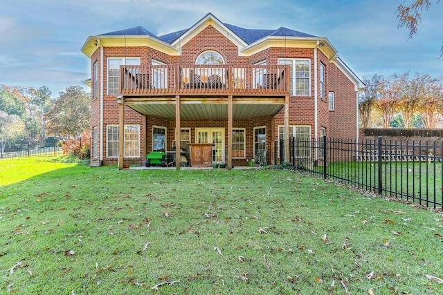 back of property featuring a lawn and a deck