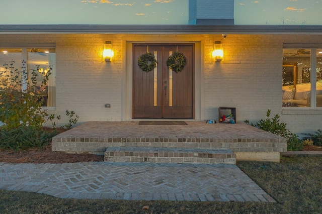 exterior entry at dusk featuring french doors