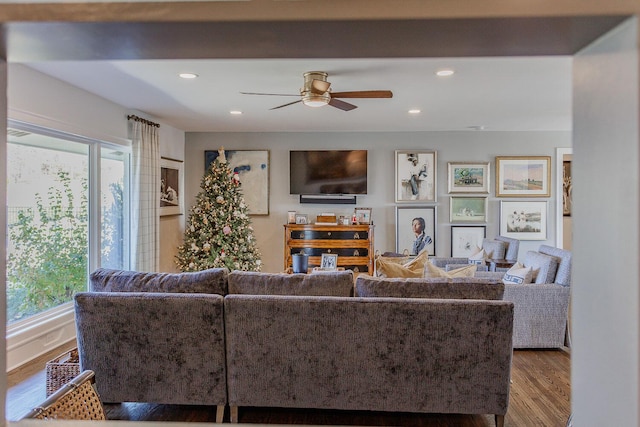 living room featuring hardwood / wood-style flooring and ceiling fan