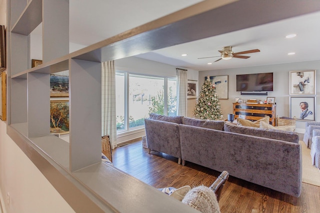 living room with ceiling fan and dark wood-type flooring