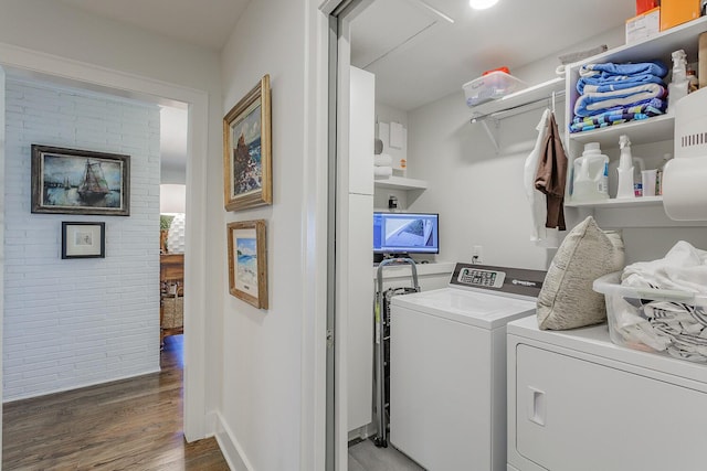 laundry room featuring separate washer and dryer and hardwood / wood-style floors