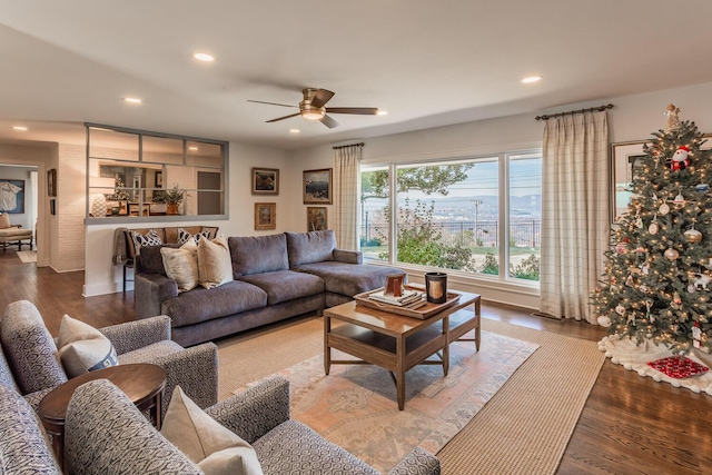 living room featuring wood-type flooring and ceiling fan