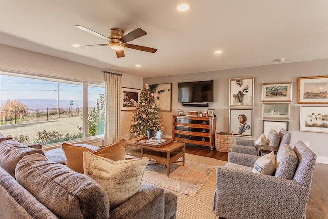 living room featuring ceiling fan and wood-type flooring