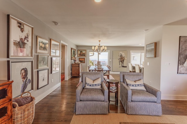 sitting room with a chandelier and hardwood / wood-style flooring