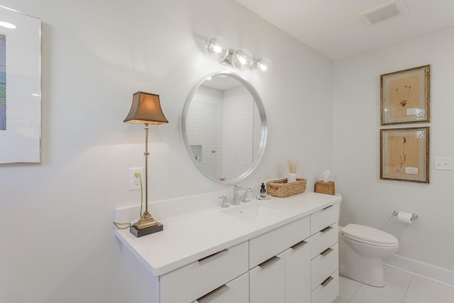 bathroom with tile patterned flooring, vanity, and toilet