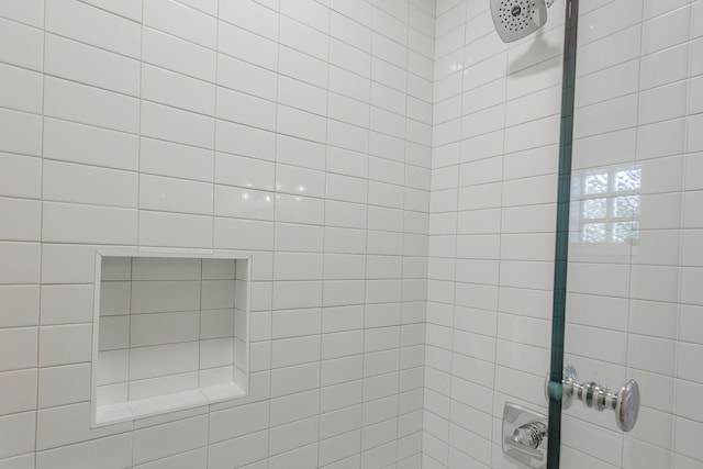 bathroom with tiled shower