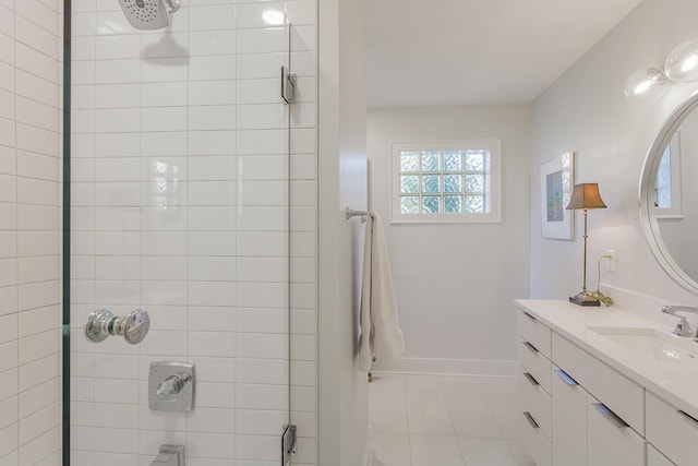 bathroom featuring tiled shower, vanity, and tile patterned floors