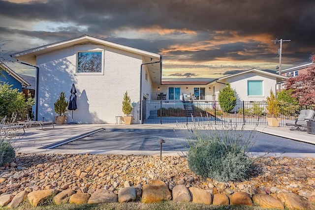 back of house featuring a patio area and a covered pool