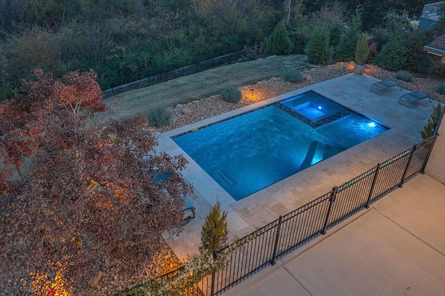 view of swimming pool with an in ground hot tub