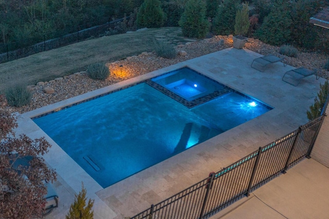 view of swimming pool featuring an in ground hot tub