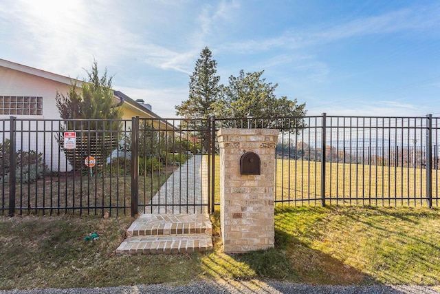 view of gate with a lawn and a water view