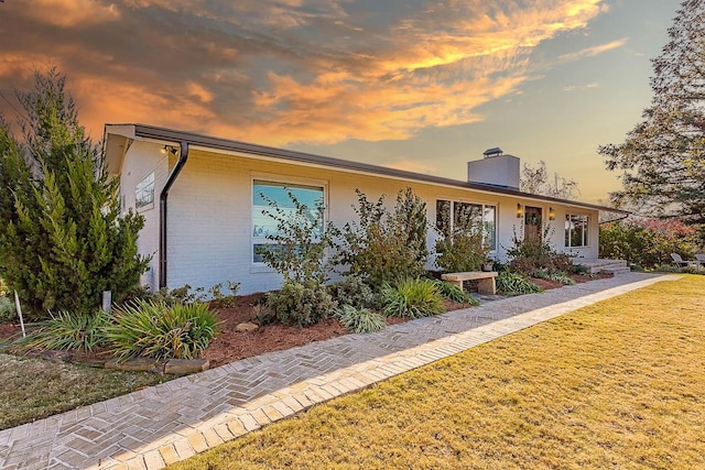 ranch-style house featuring a yard