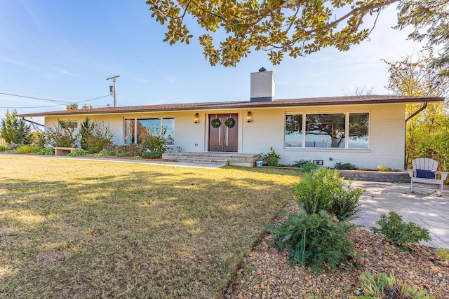 ranch-style home featuring a front yard