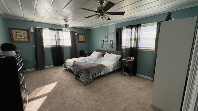 bedroom featuring multiple windows, light carpet, ceiling fan, and crown molding