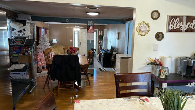 dining space featuring hardwood / wood-style floors, ceiling fan, and ornamental molding