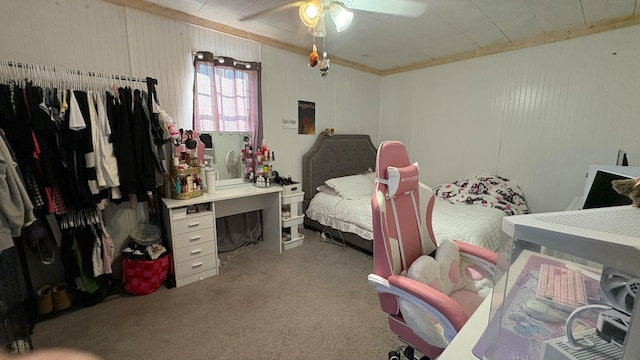 carpeted bedroom with ceiling fan and ornamental molding