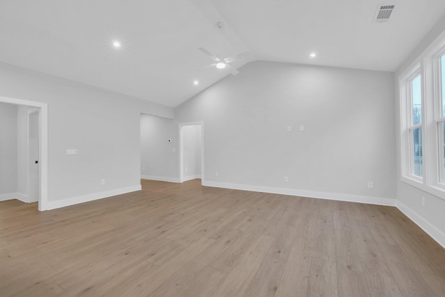 unfurnished room with ceiling fan, vaulted ceiling, and light wood-type flooring