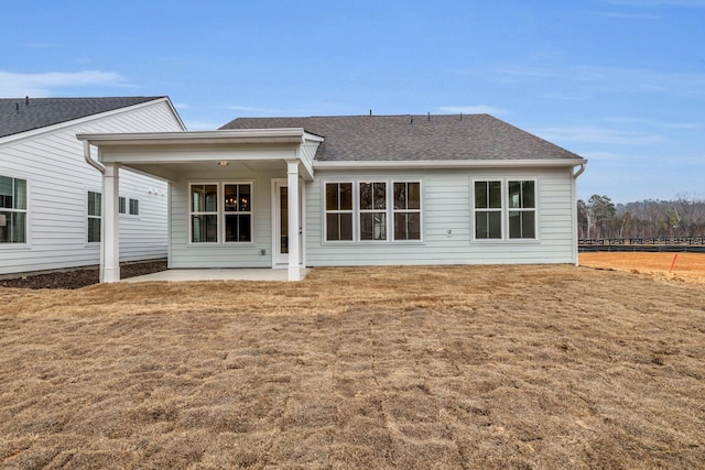 rear view of property with a lawn and a patio area