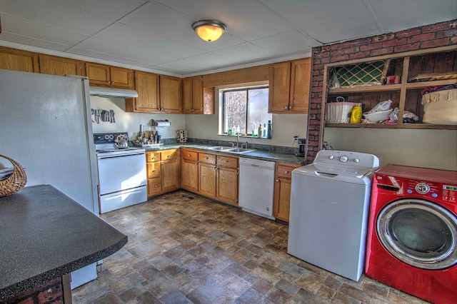 kitchen with white appliances, washing machine and dryer, and sink