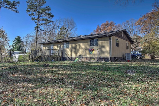 rear view of house with a deck and central AC