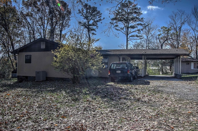 exterior space with central AC and a carport