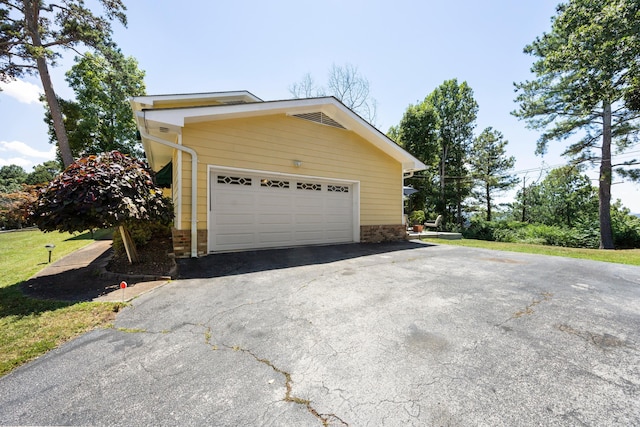 view of side of home featuring a garage