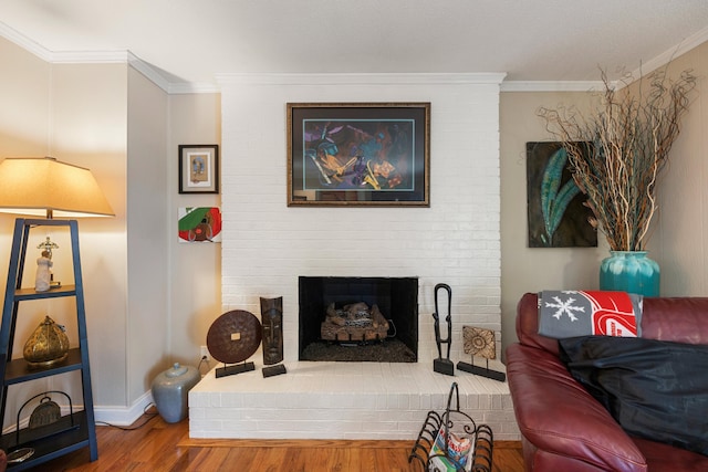 living room featuring a fireplace, hardwood / wood-style floors, and ornamental molding