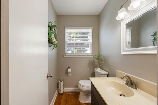 bathroom with vanity, toilet, and wood-type flooring